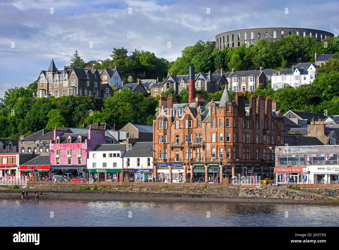 Shops and McCaig's Tower on Battery Hill overlooking the city Oban, Argyll and Bute, Scotland, UK Stock Photo