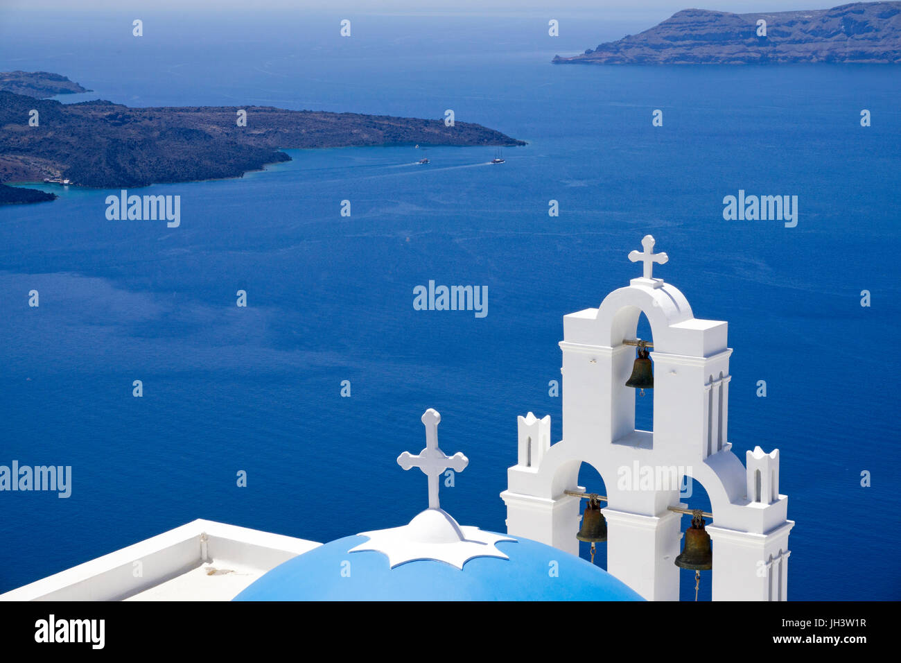Orthodox church with bell tower at the crater edge, Firofestani, Thira, view on volcanic island Nea Kameni, Santorin, Cyclades, Aegean, Greece Stock Photo