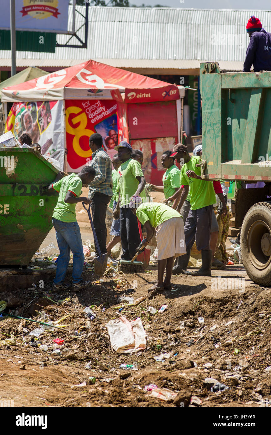 People Clearing Rubbish From Roadside And Skip As Truck Waits To Take Full Bags, Kibera, Nairobi, Kenya Stock Photo