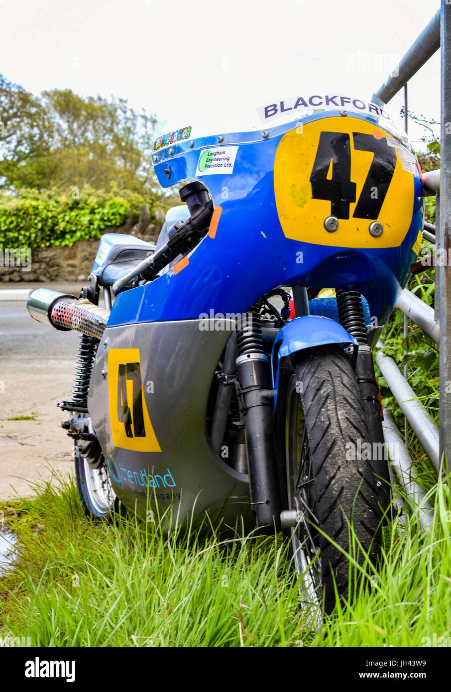 Racing motorbike retired at marshalling station at Billown Circuit Stock Photo