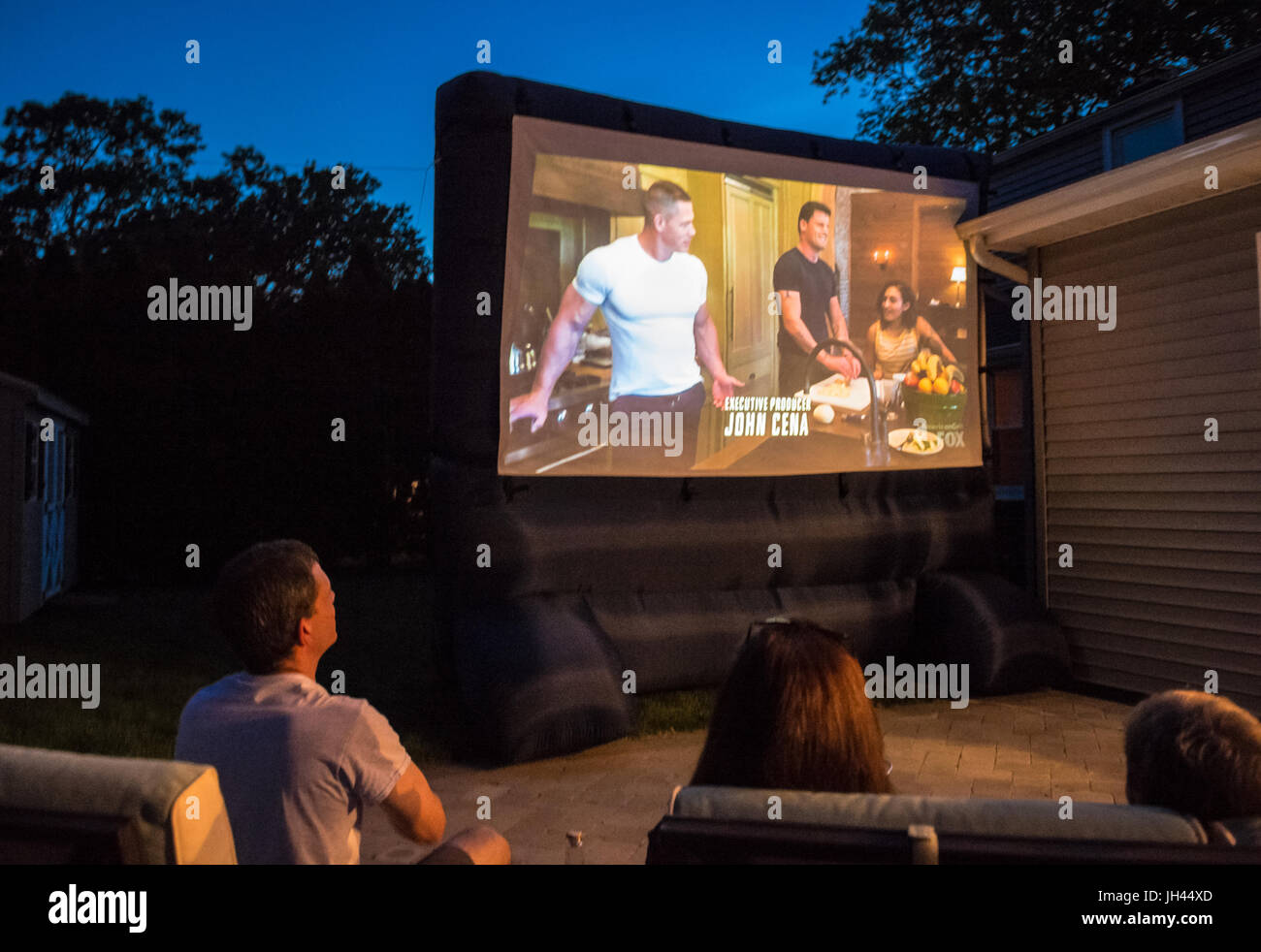 Merrick, New York, USA. 11th June 2017.  At bottom left, CHRIS EDOM, 'American Grit' TV contestant, 48, of Merrick, hosts backyard Viewing Party for S Stock Photo
