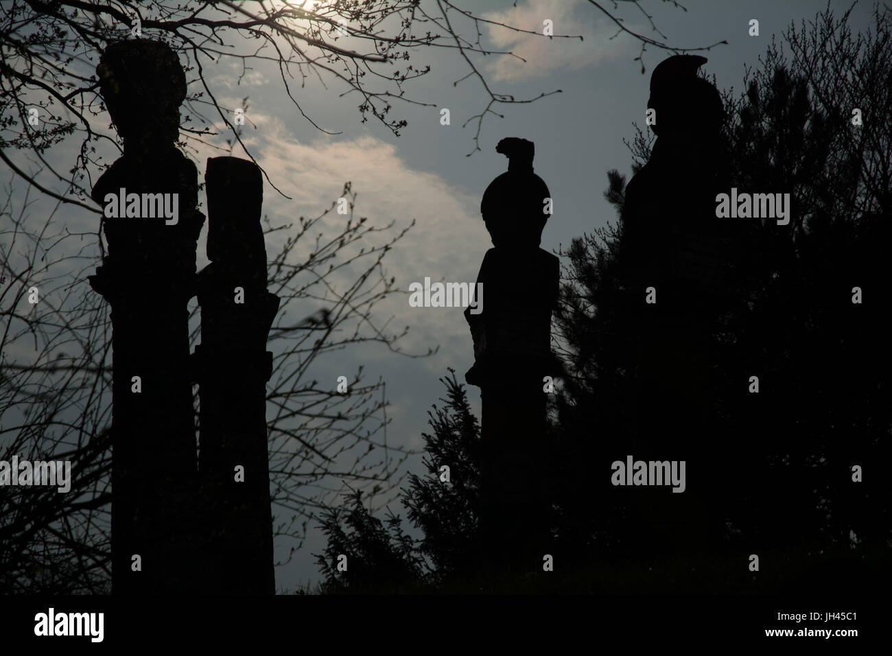 Twilight of the Gods! Silhouettes of the statues in the park against the dimming sky. Stock Photo