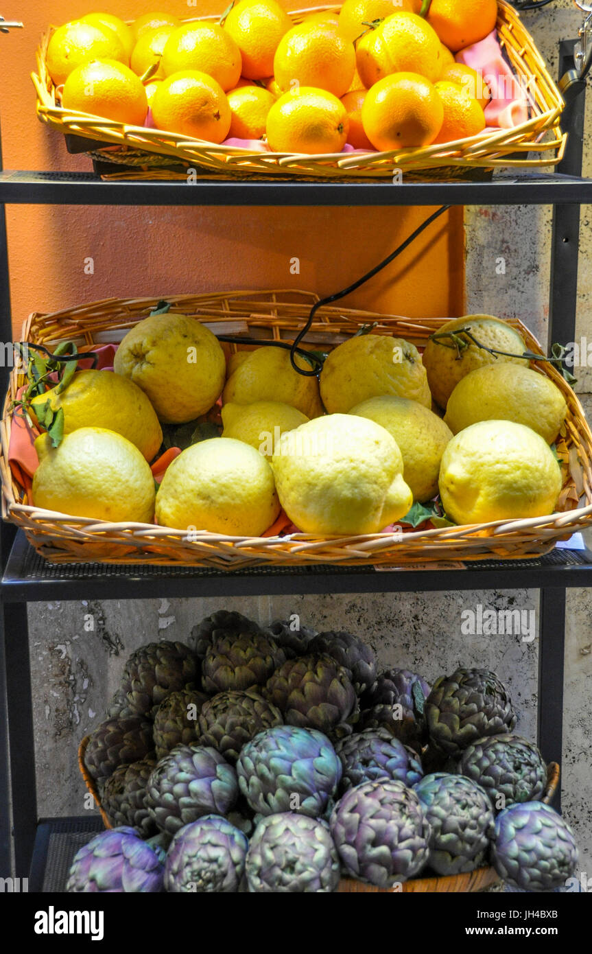 A display of oranges, lemons and artichokes. Stock Photo