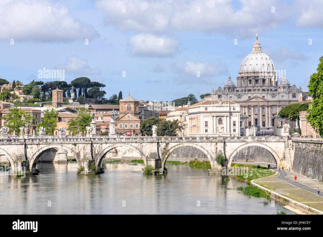Ponte Sant'Angelo, a pedestrian bridge over the Tiber River, and St Peter's Basilica in the background. Stock Photo