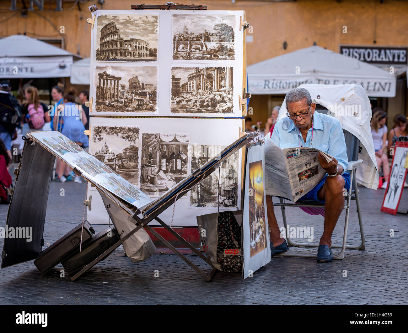Street artist reading his newspaper, Piazza Navona, Rome, Lazio, Italy Stock Photo