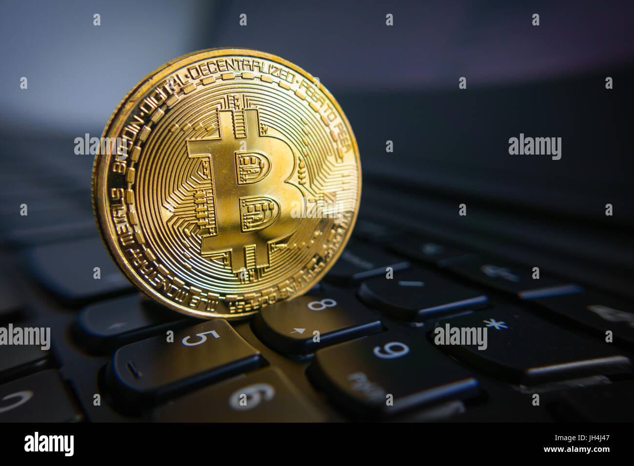Golden bitcoin coin on the black laptop keyboard Stock Photo - Alamy