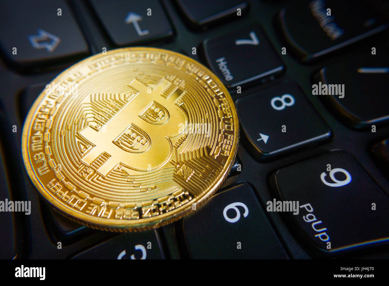 Golden bitcoin coin on the black laptop keyboard Stock Photo - Alamy
