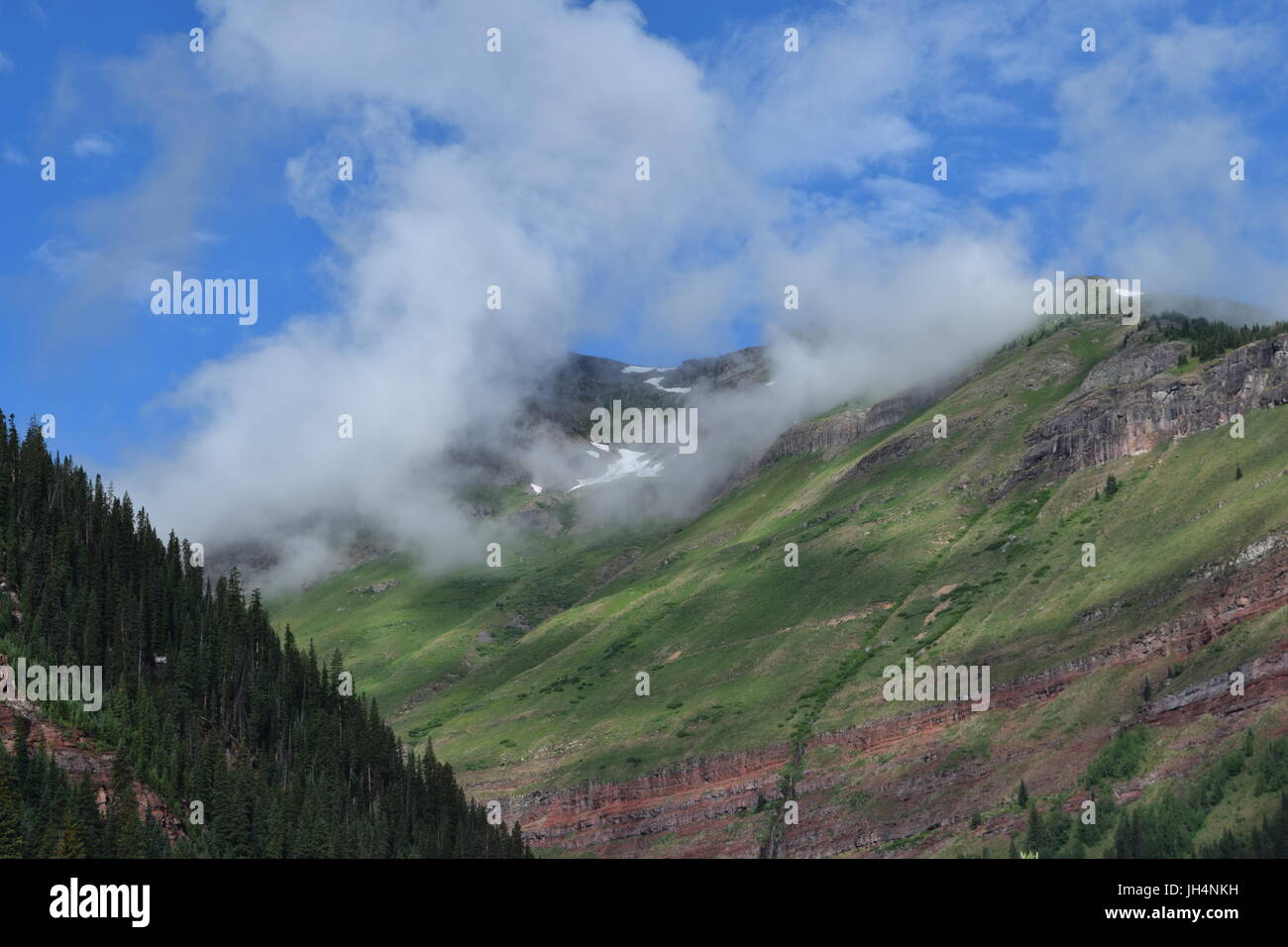 Clouds rolling over mountain tops Stock Photo - Alamy