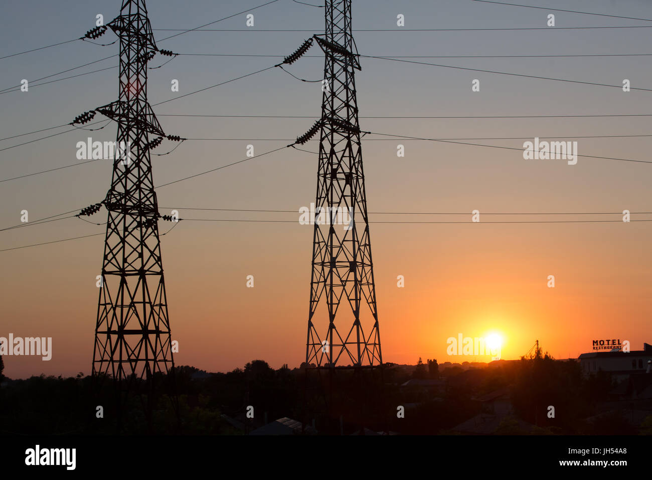 High voltage transmission power line silhouette on sunset Stock Photo ...