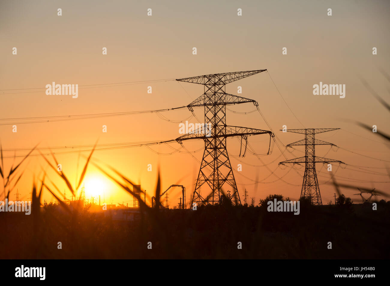 High voltage transmission power line silhouette on sunset Stock Photo ...