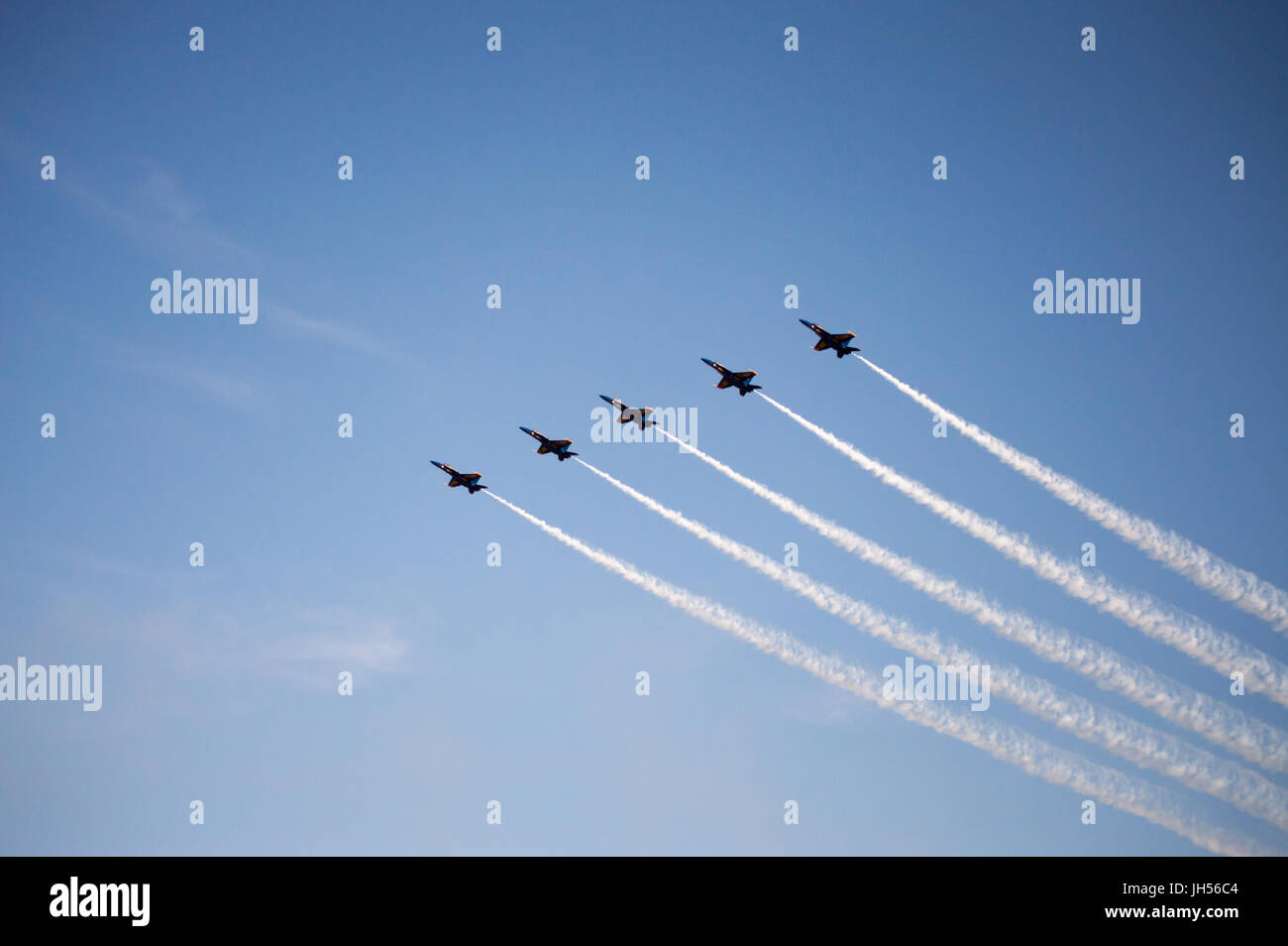 Five blue angel jets flying in formation over their home base in