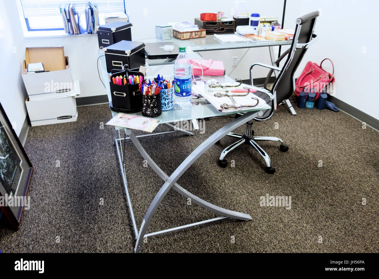 A cluttered office desk. Stock Photo