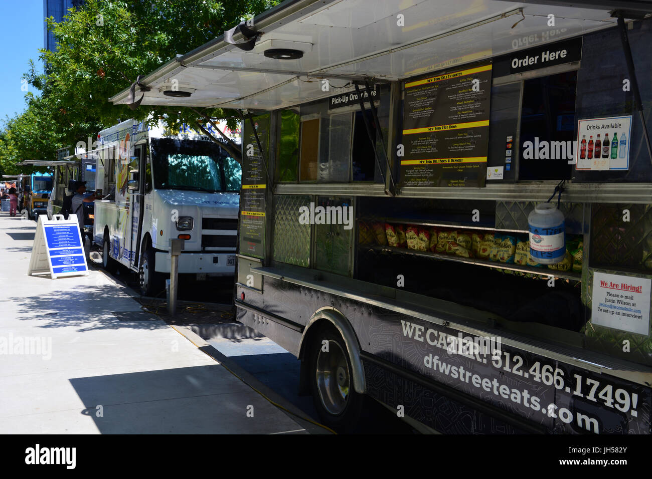 Food trucks line up during the day next to Klyde Warren Park in