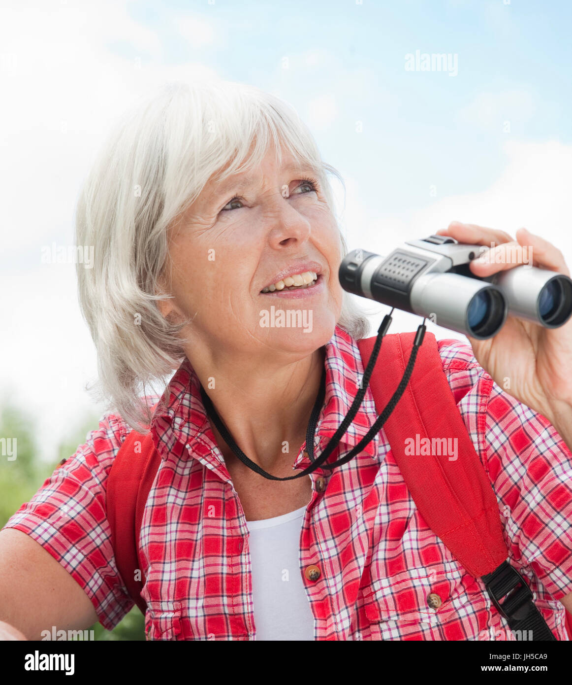 Senior lady with a pair of binoculars in the nature Stock Photo Alamy