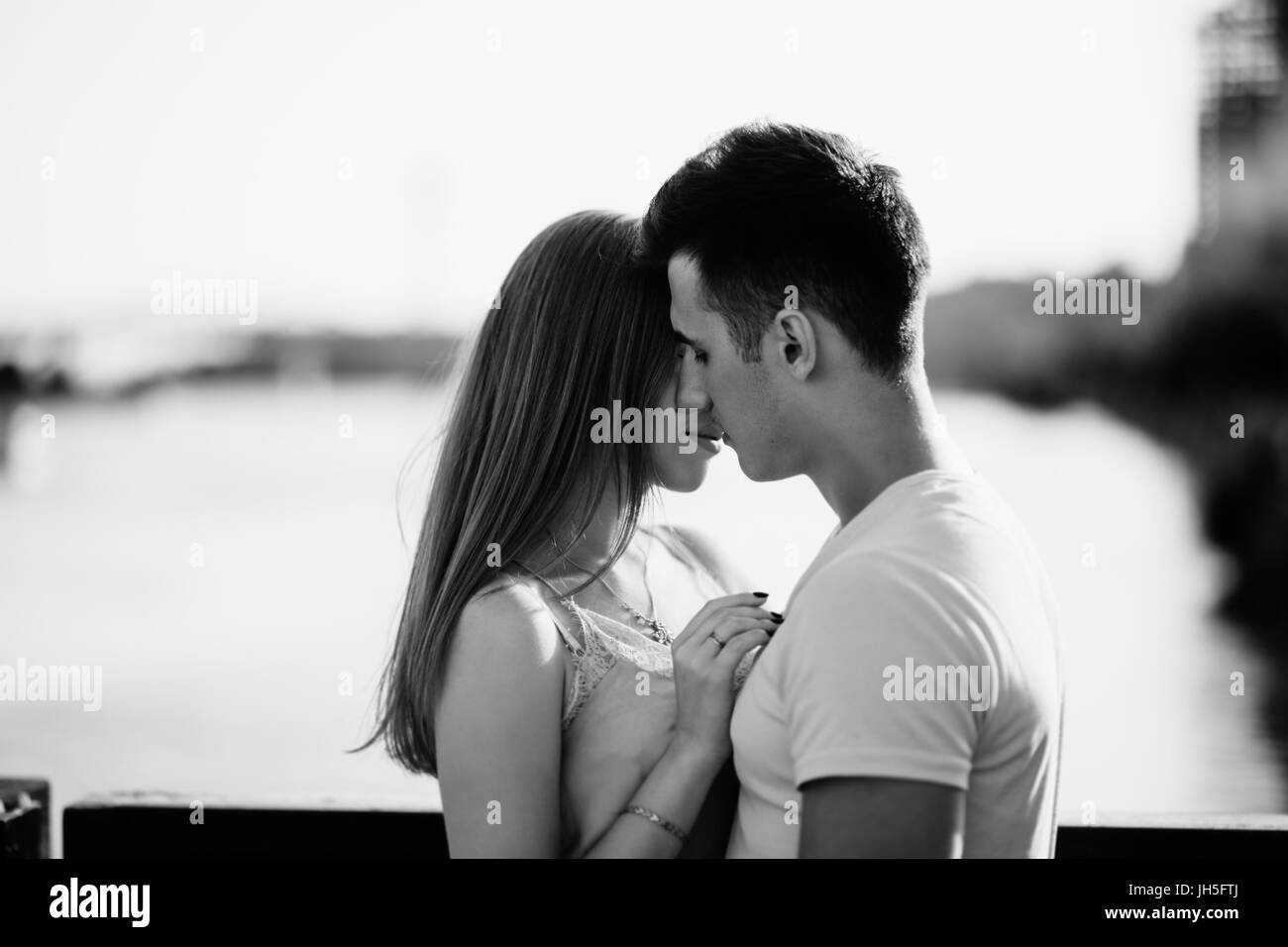 Portrait of young couple in love, enjoying the sunset in city Stock Photo