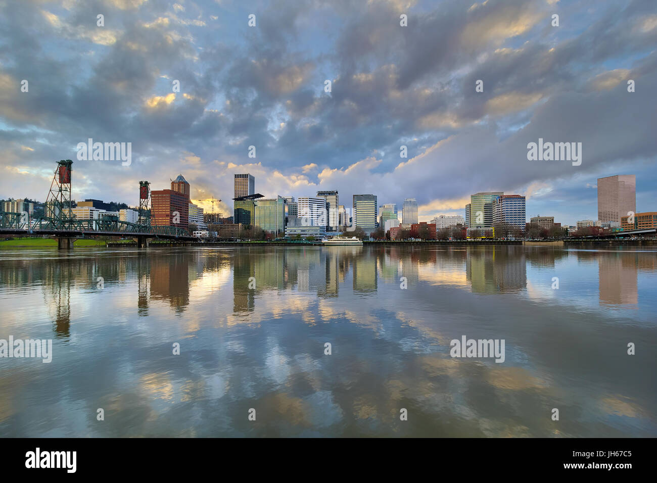 Storm Clouds over Portland Oregon city skyline along Willamette River waterfront during sunset Stock Photo