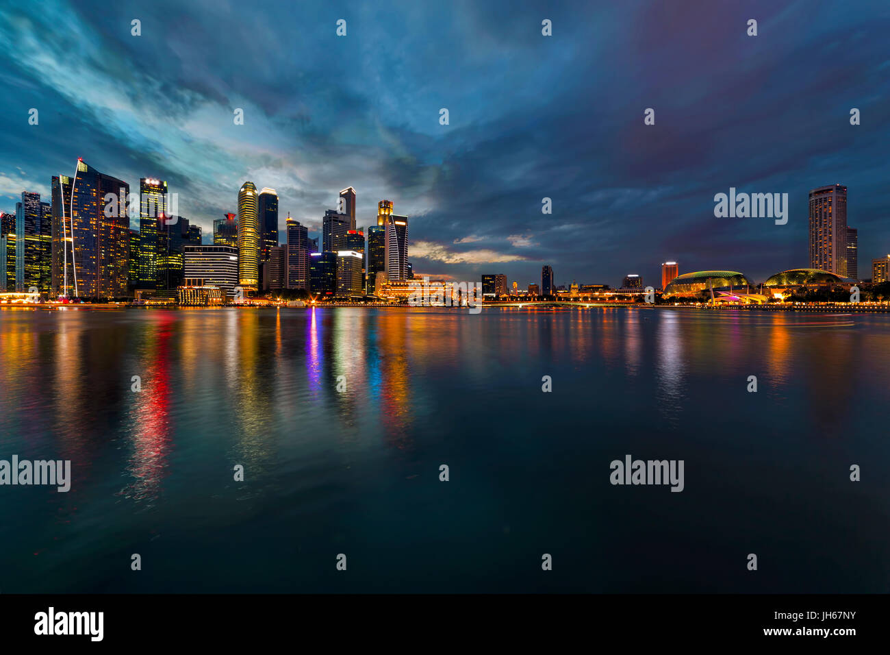 Singapore Central Business District CBD city skyline during evening twilight blue hour from Marina Bay Stock Photo