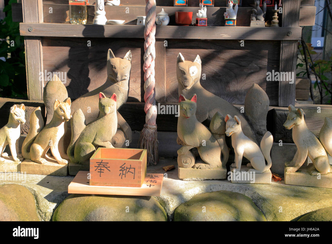 Fox Statues at Inari Shrine of Kumagawa Jinja Shinto Shrine in Fussa city Tokyo Japan Stock Photo