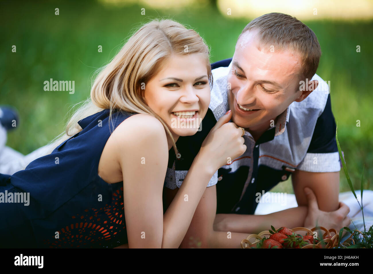 couple lying in grass Stock Photo - Alamy