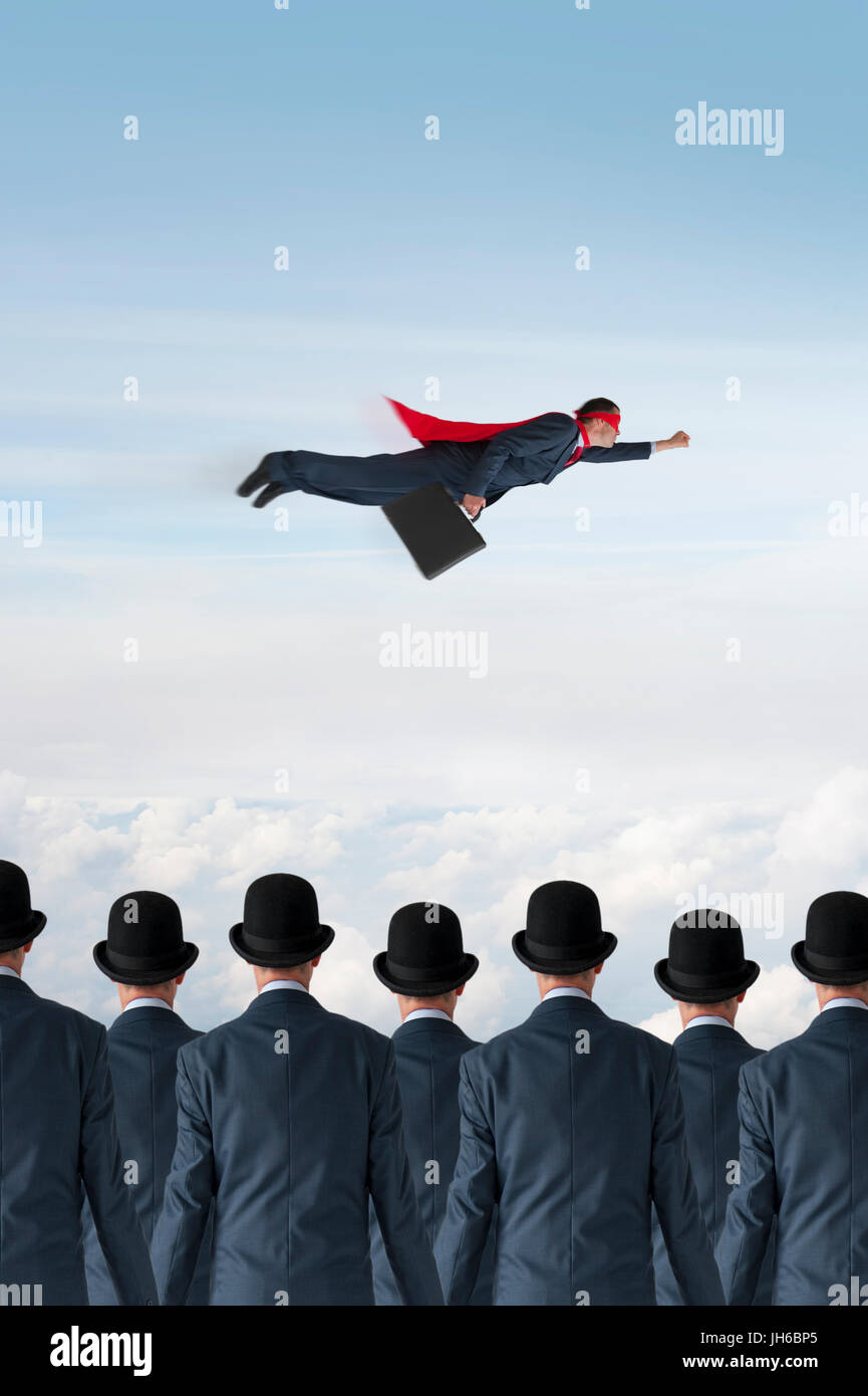 business progress concept superhero businessman flying past static competition Stock Photo