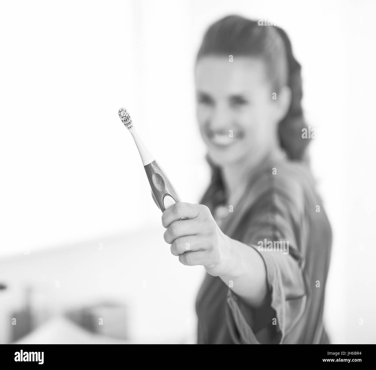 Closeup on toothbrush in hand of young woman Stock Photo