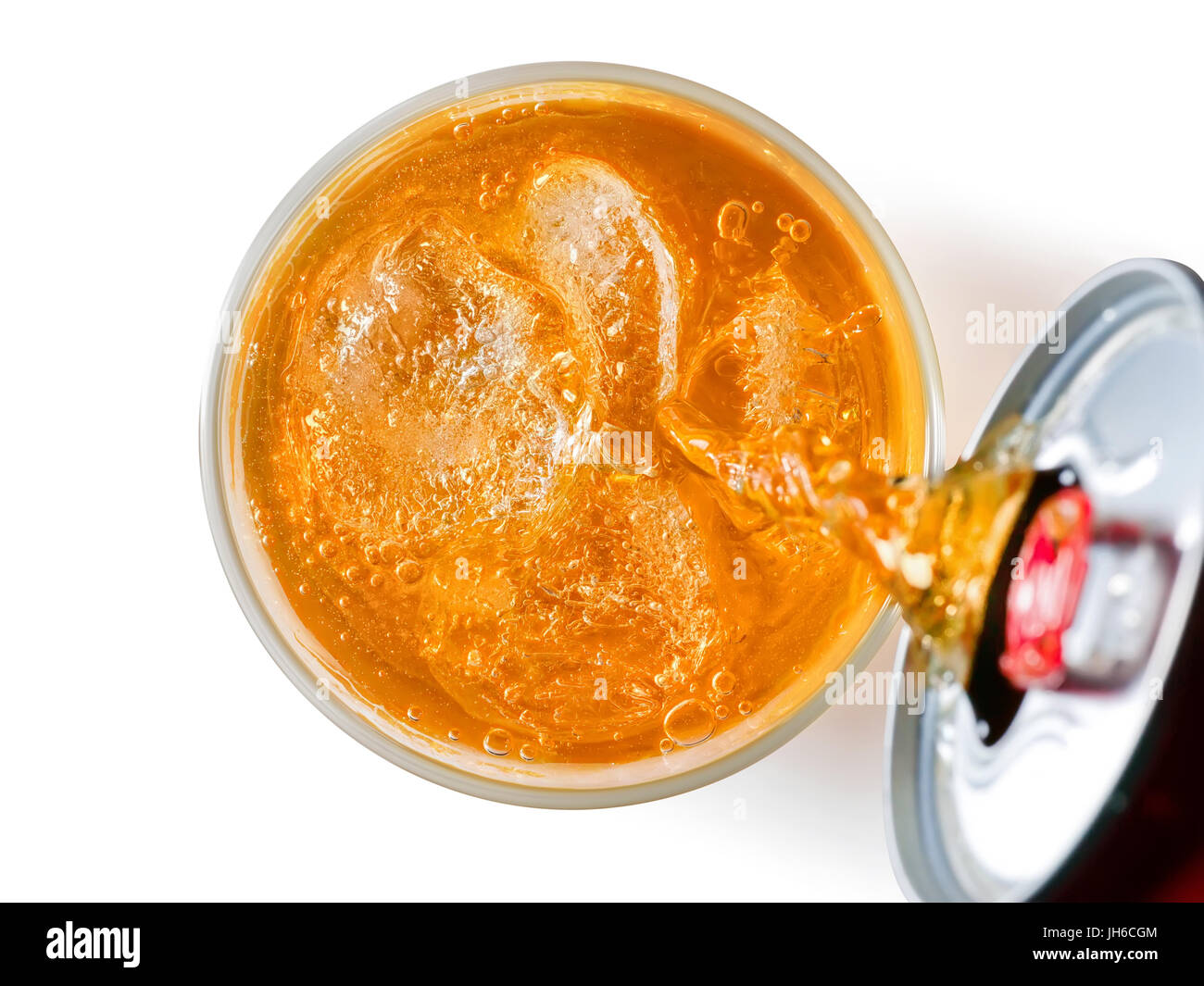 Orange soft drink liquid pouring from a can into a glass. Top view. Isolated on white, clipping path included Stock Photo