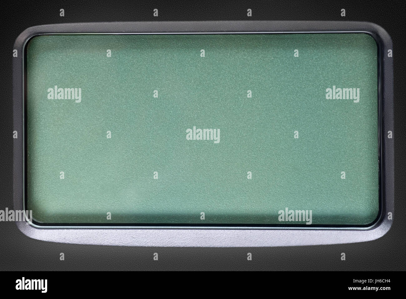 Green LCD screen in black plastic frame. Template, texture and background Stock Photo