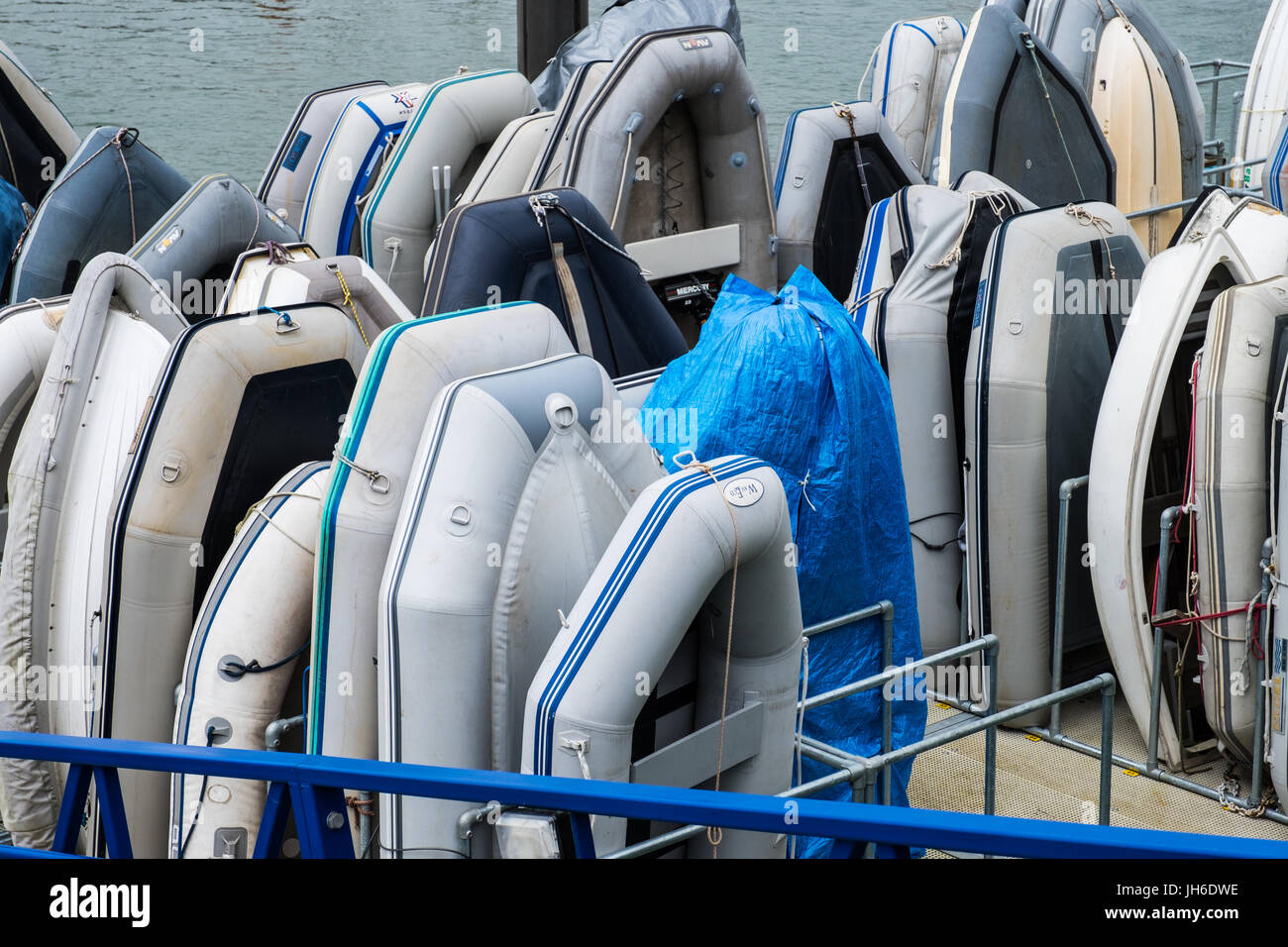 A rack of large and small inflatable boats. Stock Photo