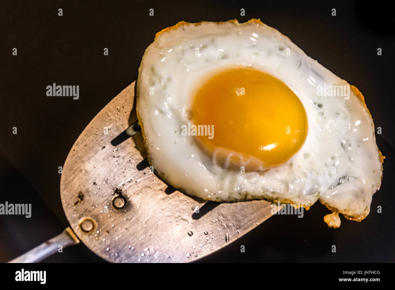 Photograph of a fried egg and metal spatula Stock Photo Alamy
