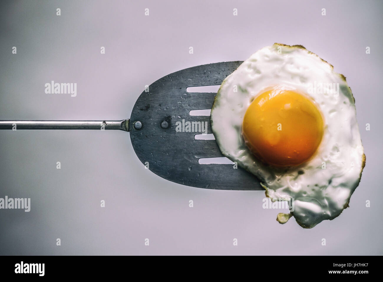 Photograph of a fried egg and metal spatula Stock Photo Alamy