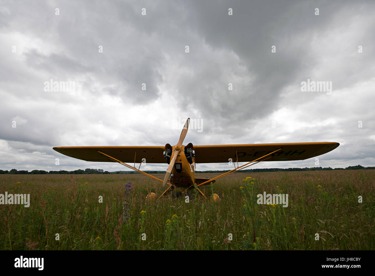 an old airplane on a field ready to take off Stock Photo