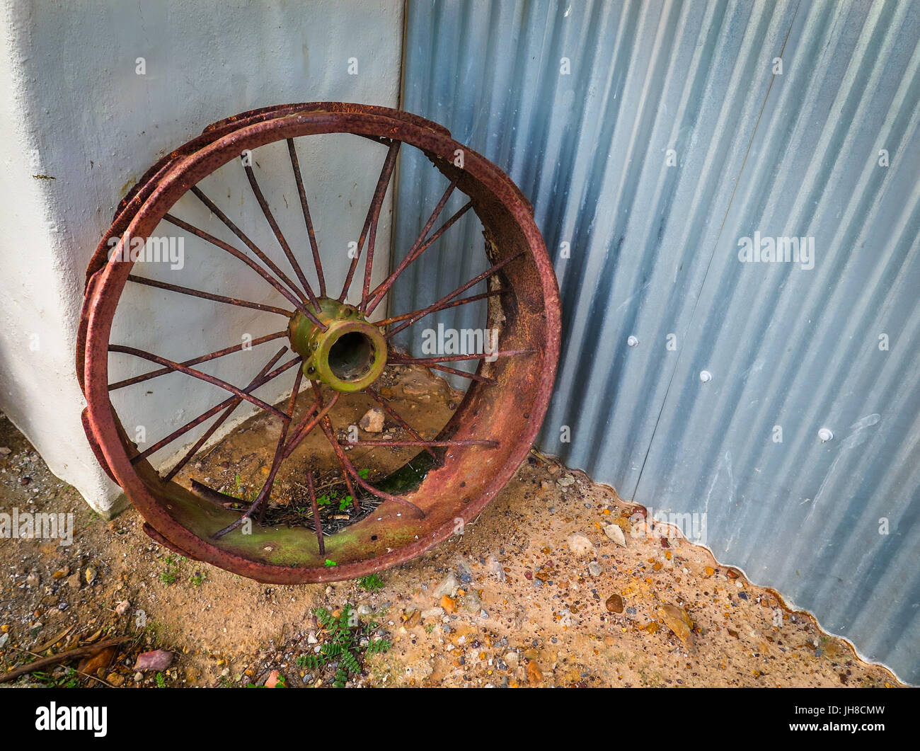 Old vintage car rim lies abandoned in a corner of a barn on a farm near Cape Town, South Africa. Stock Photo