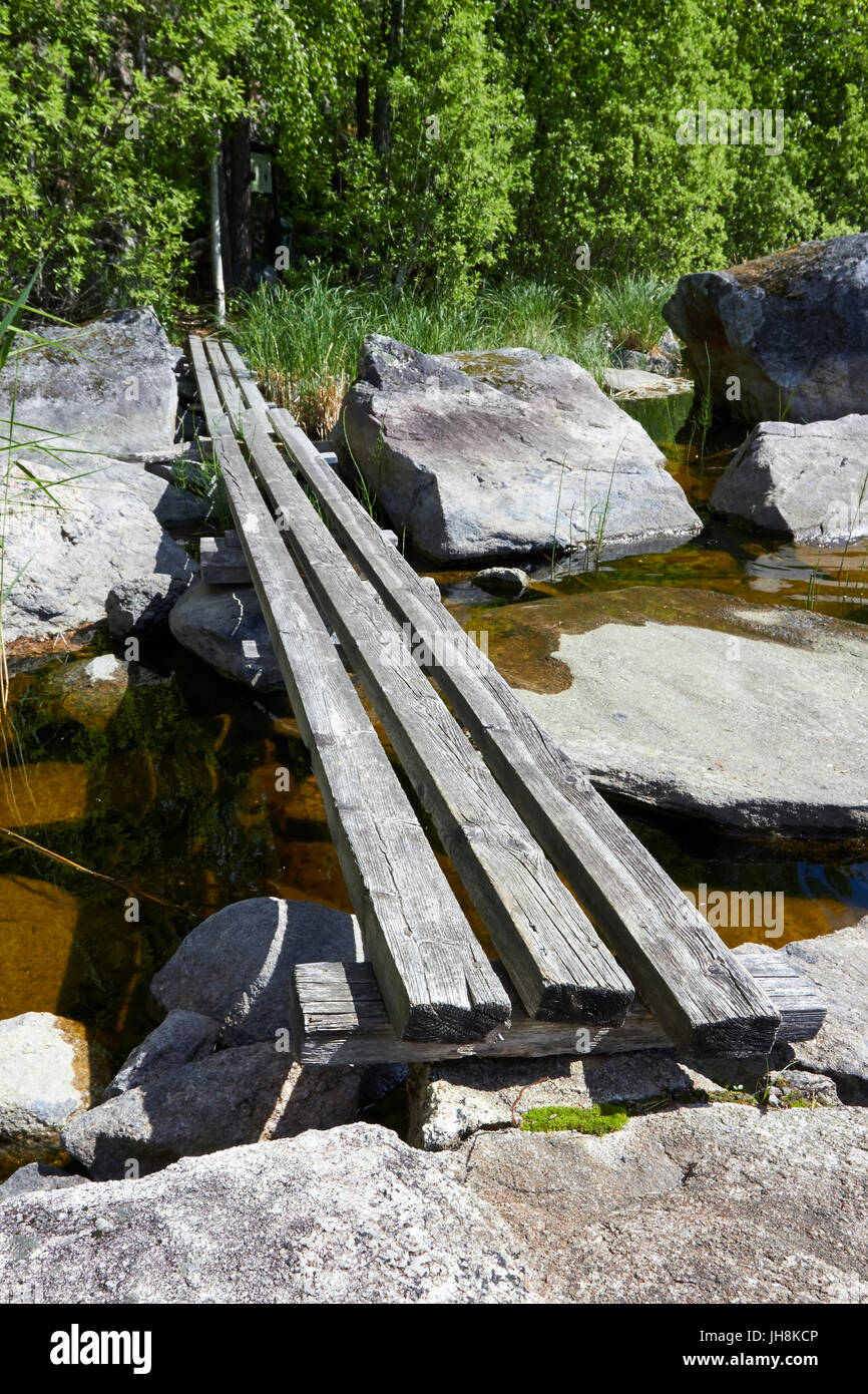 Makeshift wooden bridge over water Stock Photo - Alamy