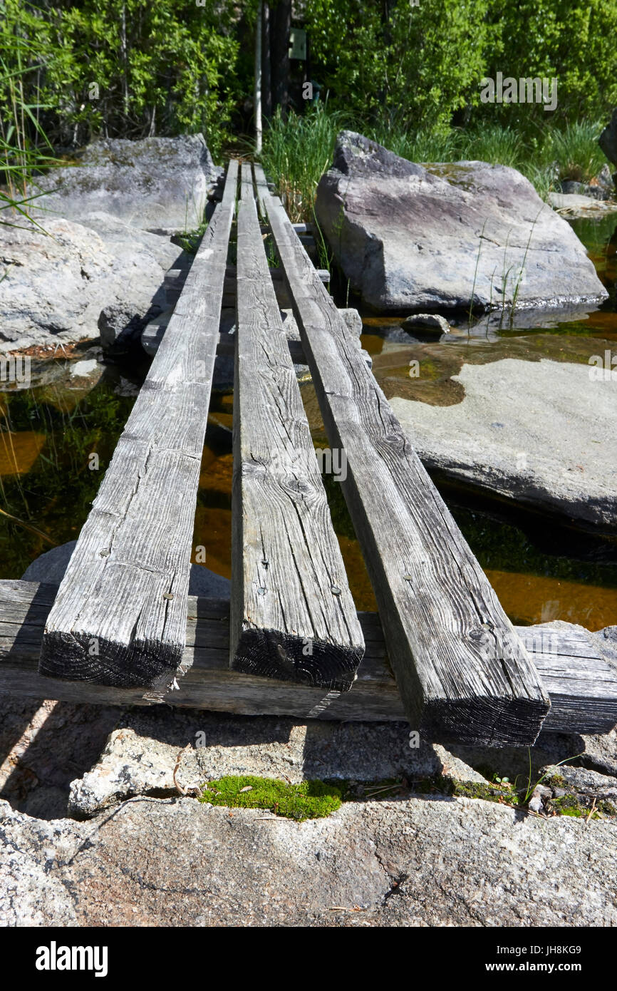 Makeshift wooden bridge over water Stock Photo - Alamy