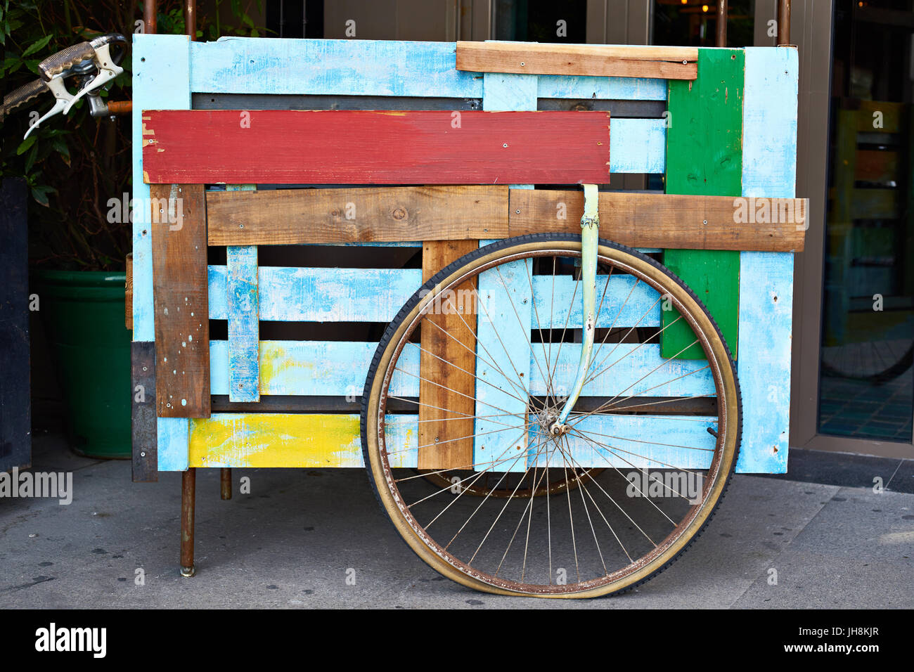 Decorative colored wooden cart with a wheel Stock Photo
