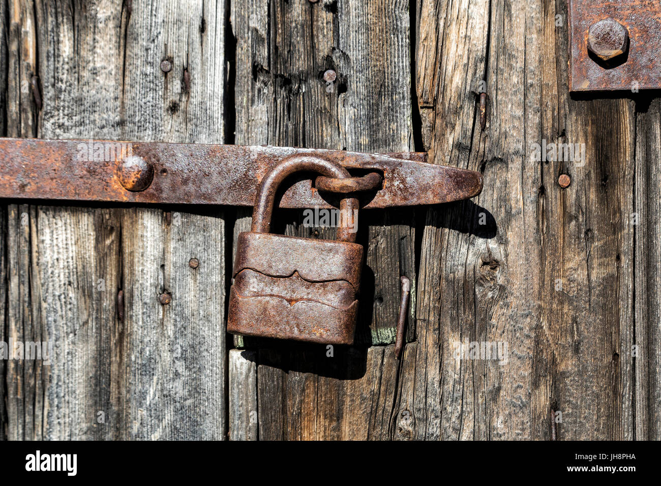 Old wooden door with rusty padlock Stock Photo - Alamy