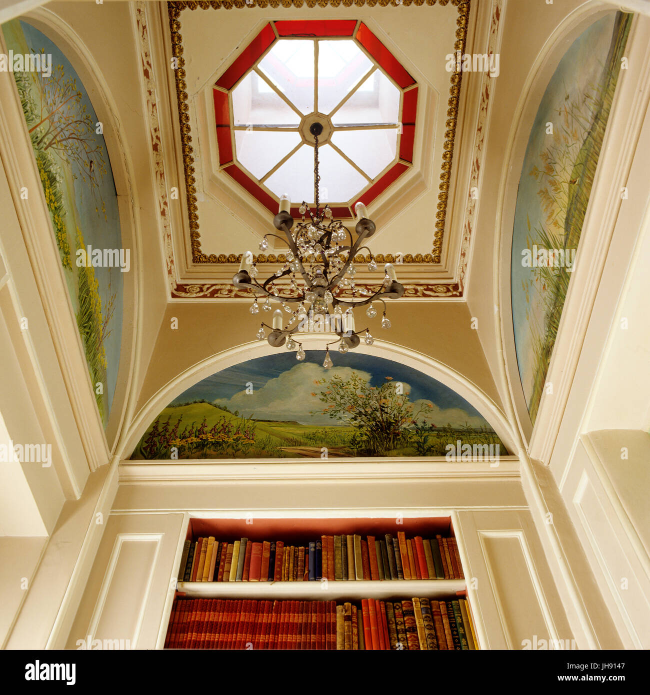 Chandelier hanging from a skylight in a library Stock Photo