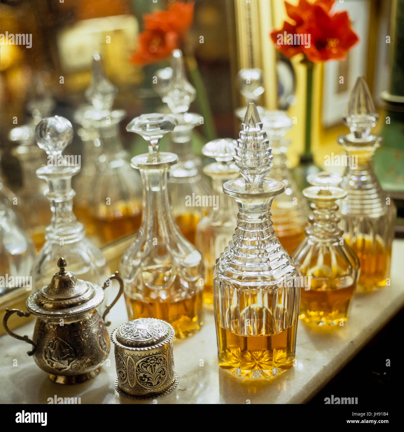 Whiskey decanters by mirror Stock Photo