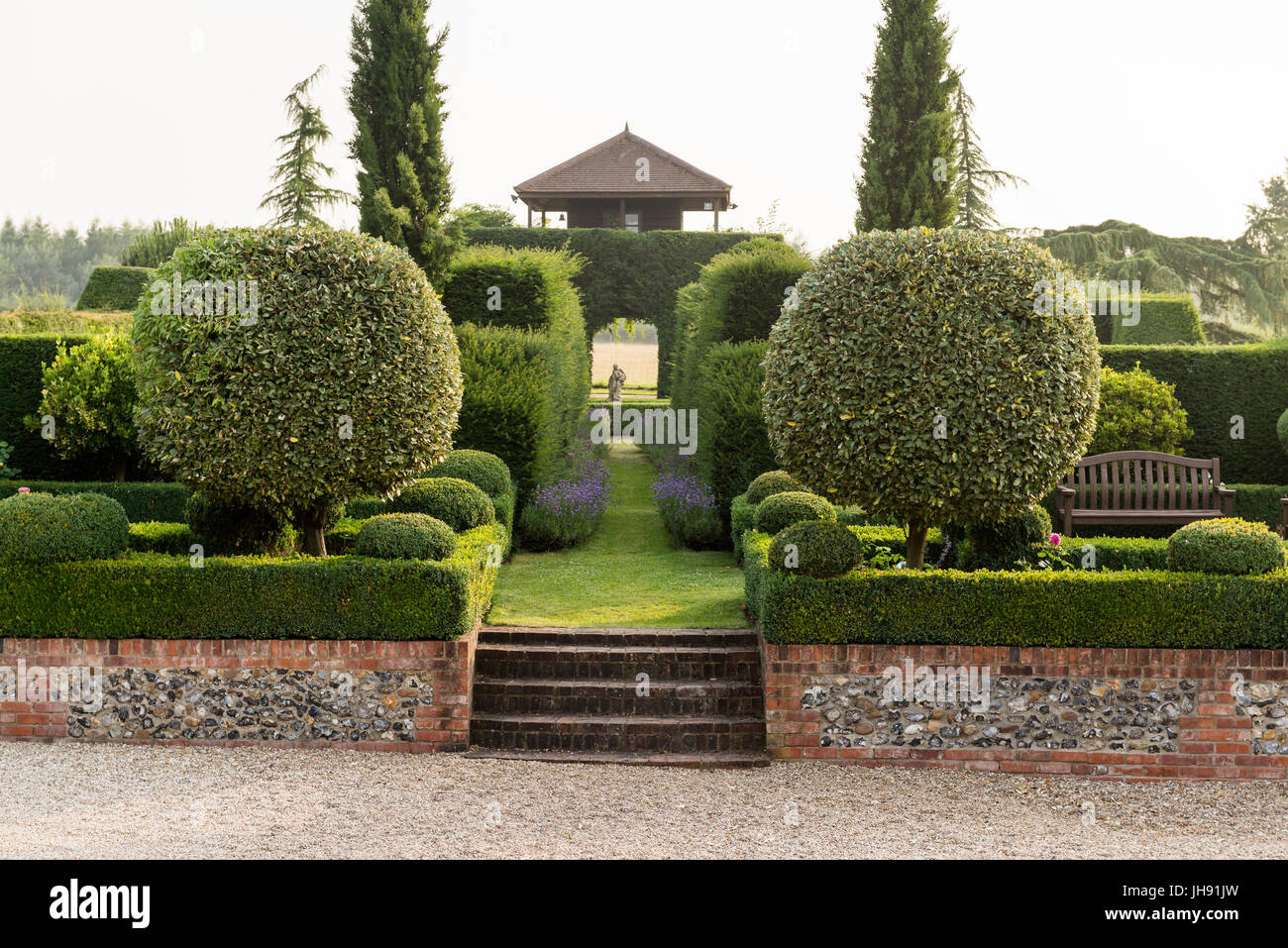 Brick wall and stairs in hedge garden Stock Photo Alamy