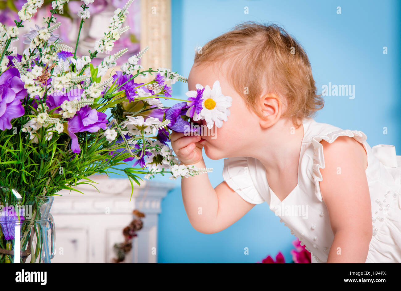 Little girl smelling a flower Stock Photo - Alamy