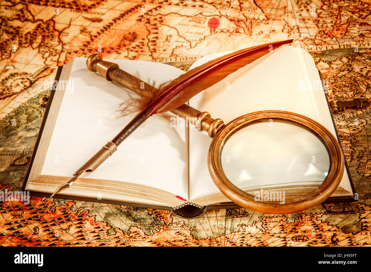 Vintage still life - magnifying glass, old book and goose quill pen ...