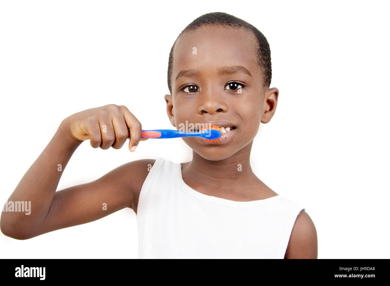 This smiling little boy brushing his teeth. Stock Photo
