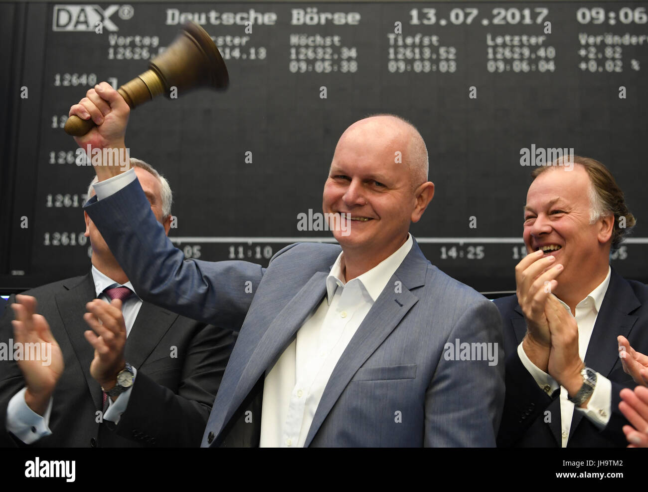 Frankfurt, Germany. 13th Jul, 2017. Olaf Koch (C), CEO of der Metro Wholesale & Food Specialist AG, rings the stock exchange bell beside Gregor Pottmeyer (l), CFO of Deutsche Boerse AG, and Metro board member Pieter Boone, during the flotation of the new Metro on the trading floor at the stock exchange in Frankfurt am Main, Germany, 13 July 2017. Credit: dpa picture alliance/Alamy Live News Stock Photo