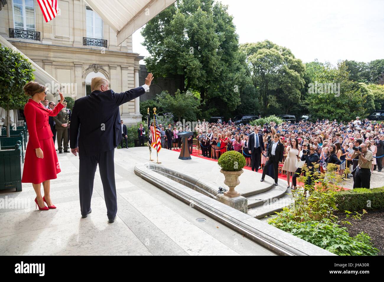 Paris, France. 13th July, 2017. U.S. President Donald Trump and First Lady Melania Trump wave as they arrive for an event honoring veterans at the U.S. Embassy July 13, 2017 in Paris, France. The first family is in Paris to commemorate the 100th anniversary of the United States' entry into World War I and attend Bastille Day celebrations. Credit: Planetpix/Alamy Live News Stock Photo