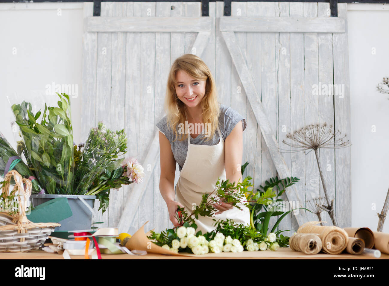 Photo of smiling florist woman at work in flower shop Stock Photo - Alamy