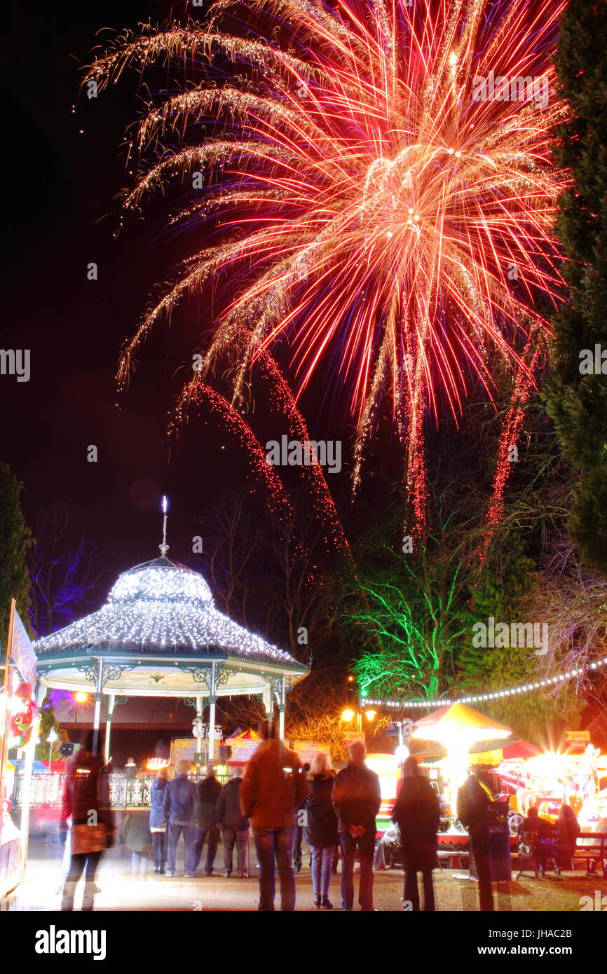 Shoppers pause to see magnificent firework display at Matlock's Victorian Christmas Market in Hall Leys Park, Matlock, Derbyshire Dales, England UK Stock Photo