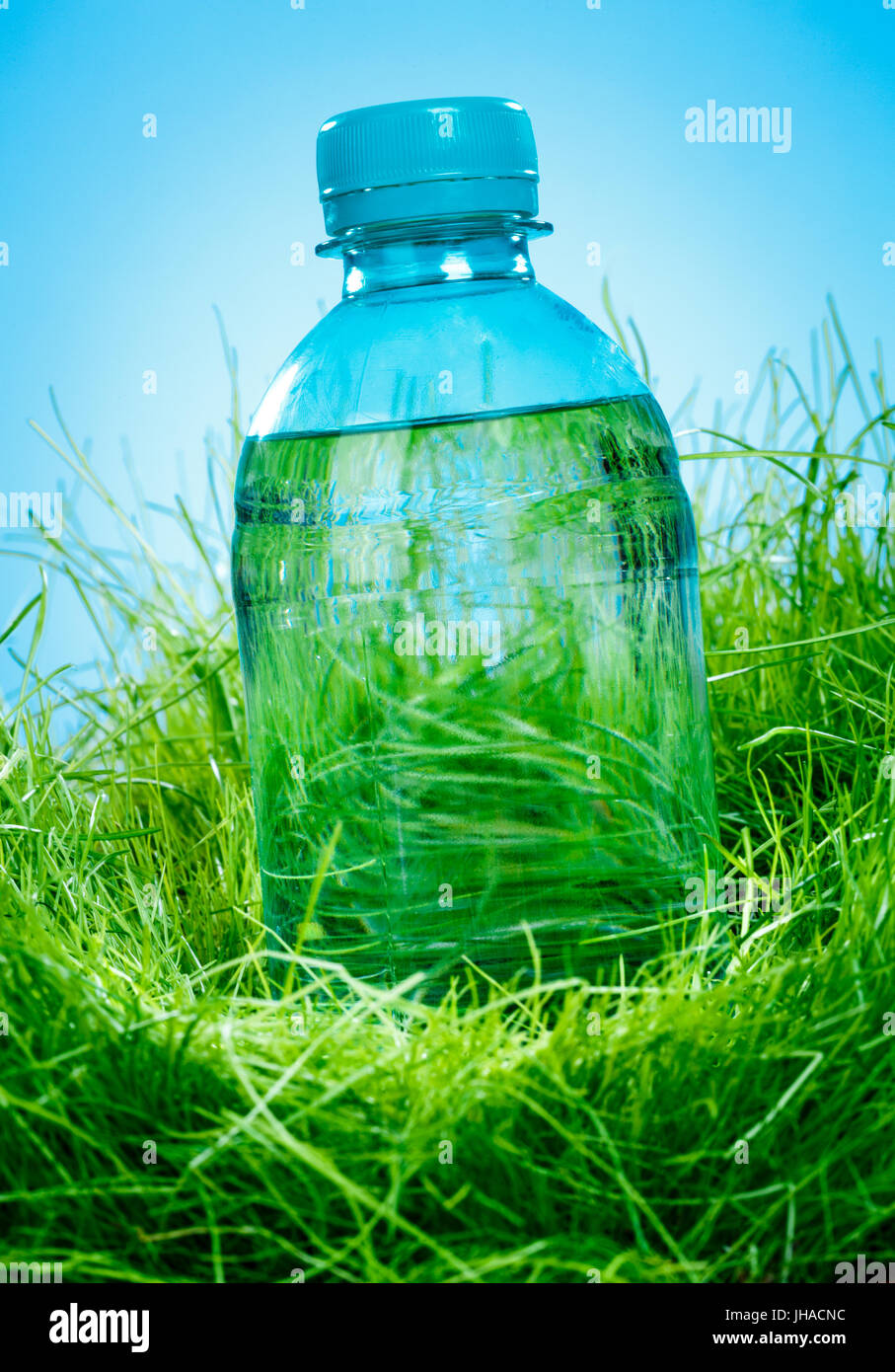 Bottle of water on the green grass Stock Photo - Alamy