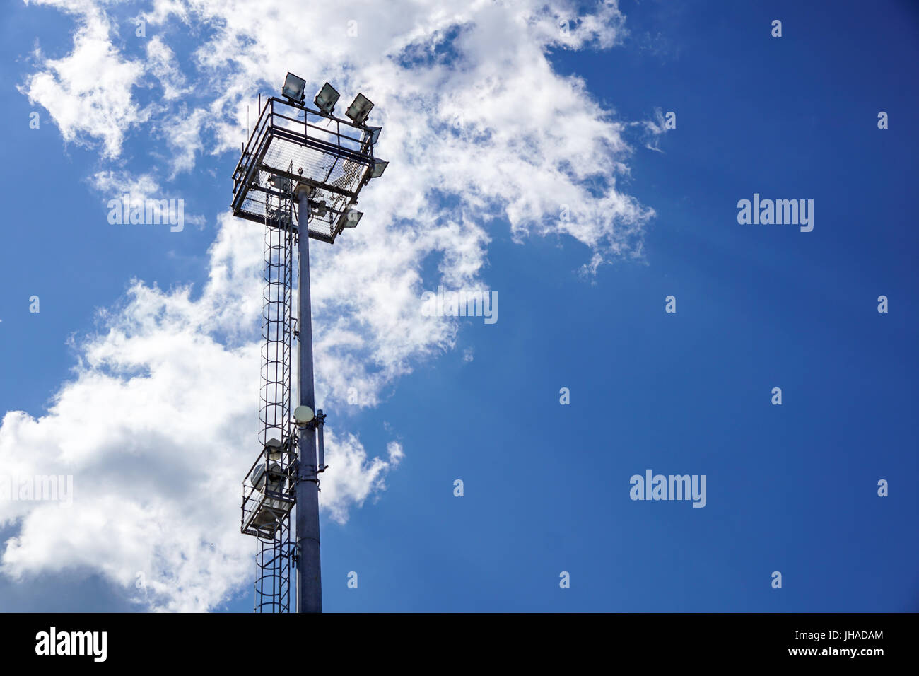 Stadium lighting pole light field at day bright blue Stock Photo