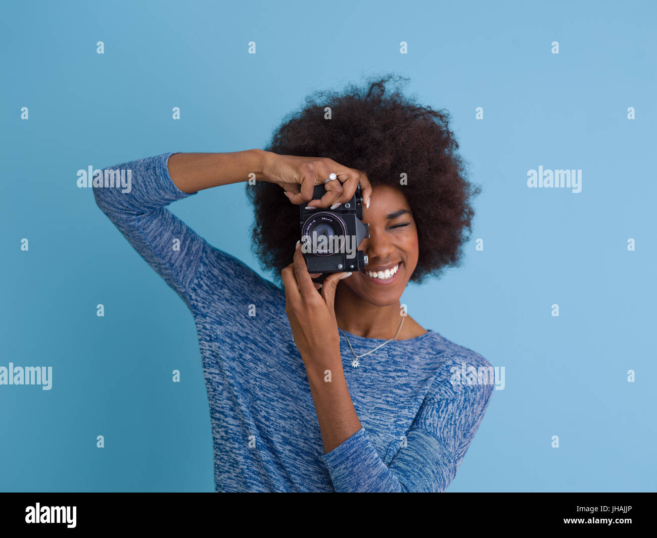 portrait of a smiling pretty african american girl taking photo on a ...