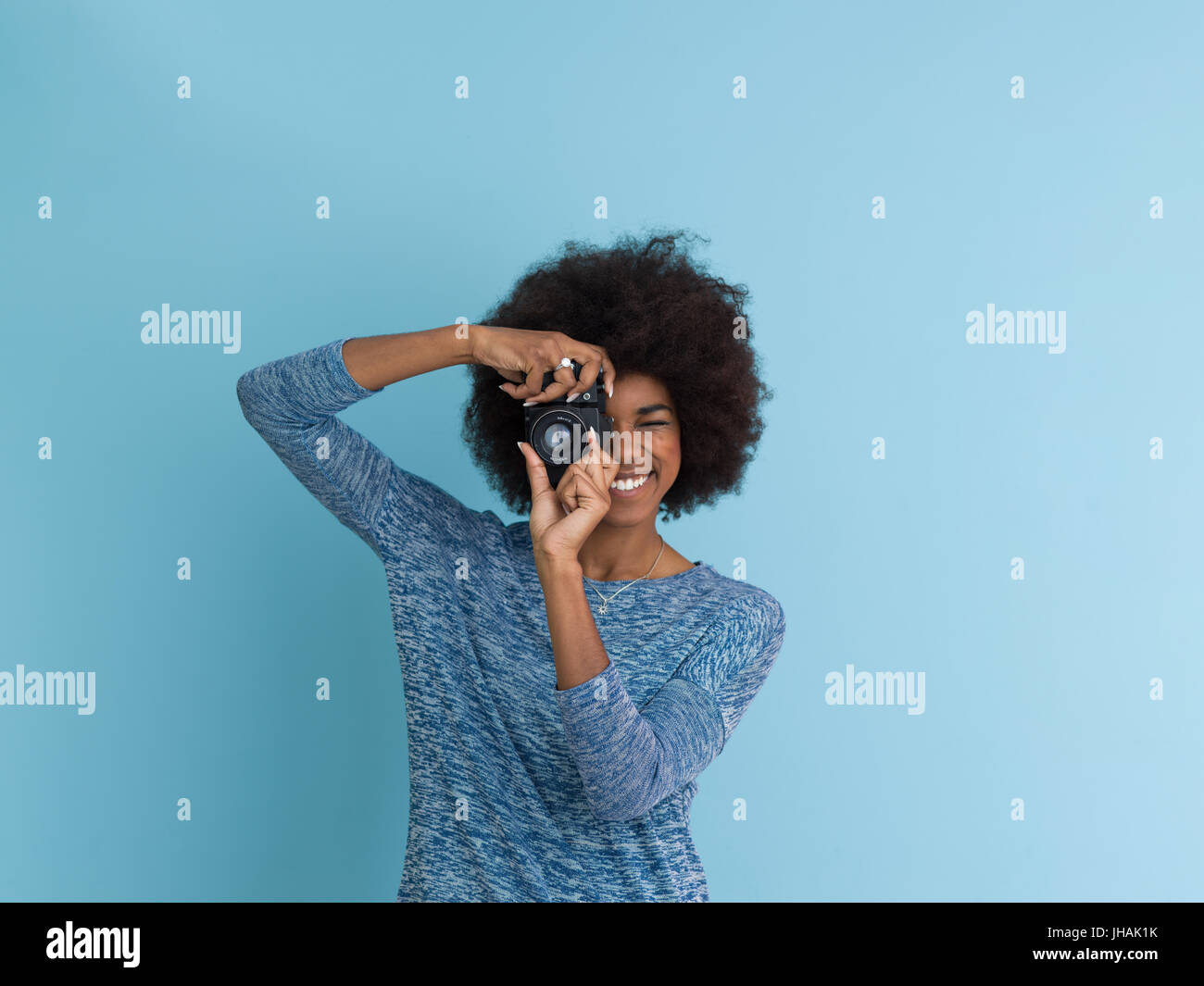 portrait of a smiling pretty african american girl taking photo on a ...